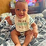 Roman is registered to the contest to win money with this photo: baby, bib, blanket, child, cozy, cute, expression, face, feet, hand, happy, home, indoor, infant, person, portrait, sitting, smiling, striped_clothing, young_child