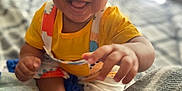 Roman is registered to the contest to win money with this photo: baby, bed, blanket, child, clothing, colorful, cozy, cute, expressive, face, happy, indoor, infant, person, playful, portrait, reaching_hand, sitting, smiling, young_child