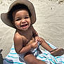 barefoot, beach, child, cute, footwear, happy, hat, outdoor, playful, portrait, sand, sandals, sitting, smile, summer, sunhat, sunlight, toddler, towel, vacation