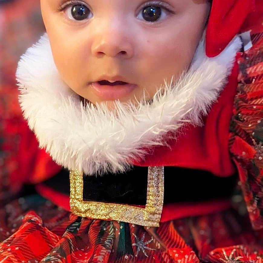 Isabella is registered to the contest to win money with this photo: accessories, baby, bonnet, clothing, coat, costume, doll, dress, face, festival, happy, hat, head, hood, jacket, person, photography, portrait, smile, toy