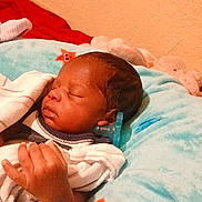 Anthony is registered to the contest to win money with this photo: newborn, baby, sleeping, infant, portrait, face, pacifier, blanket, bed, nursery, cozy, indoors, child, closed_eyes, peaceful, plush_toy, red_blanket, blue_blanket, white_clothing, resting
