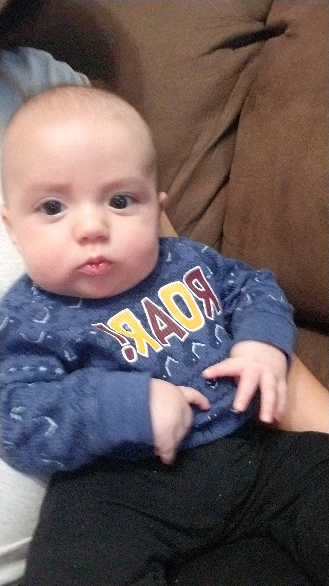 Forrest is registered to the contest to win money with this photo: baby, baby_toddler_clothing, cheek, child, comfort, couch, eye, eyebrow, finger, iris, lap, lip, mouth, nose, person, sitting, skin, sleeve, t_shirt, textile