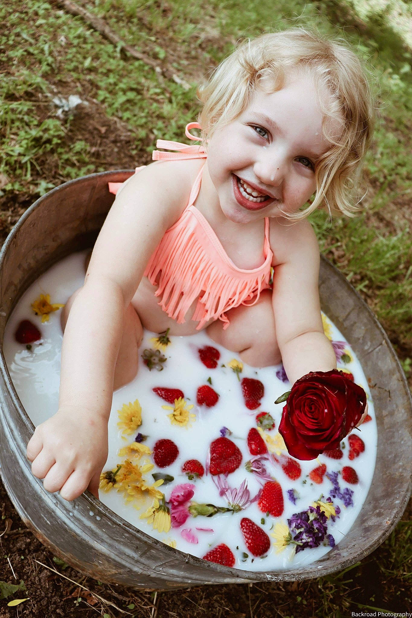 Willow is registered to the contest to win money with this photo: baby_toddler_clothing, berry, cake, cake_decorating, child, cuisine, dress, face, fruit, grass, happy, joy, people_in_nature, person, petal, plant, recipe, rose, smile, strawberry