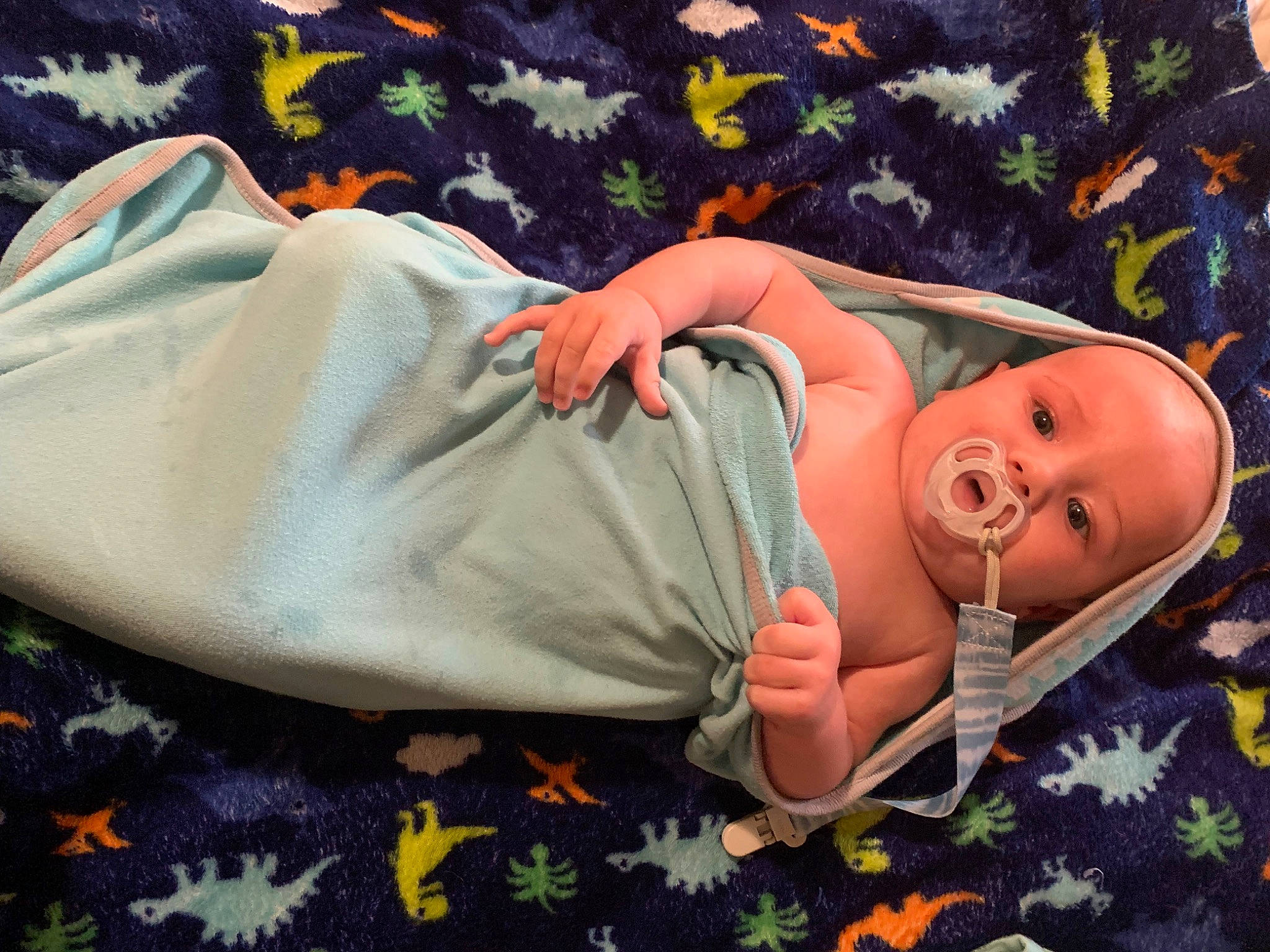 Landon is registered to the contest to win money with this photo: arm, baby, baby_products, baby_safety, baby_sleeping, baby_toddler_clothing, bedding, bedtime, comfort, finger, grass, hand, human_body, linens, mammal, orange, person, room, sleeve, toddler