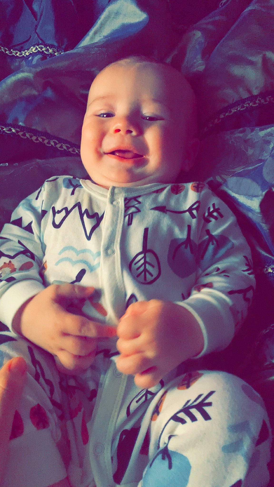 Landon is registered to the contest to win money with this photo: baby_toddler_clothing, cheek, chin, eye, eyebrow, face, finger, gesture, hand, happy, head, human_body, iris, lip, mouth, nose, person, pink, skin, sleeve