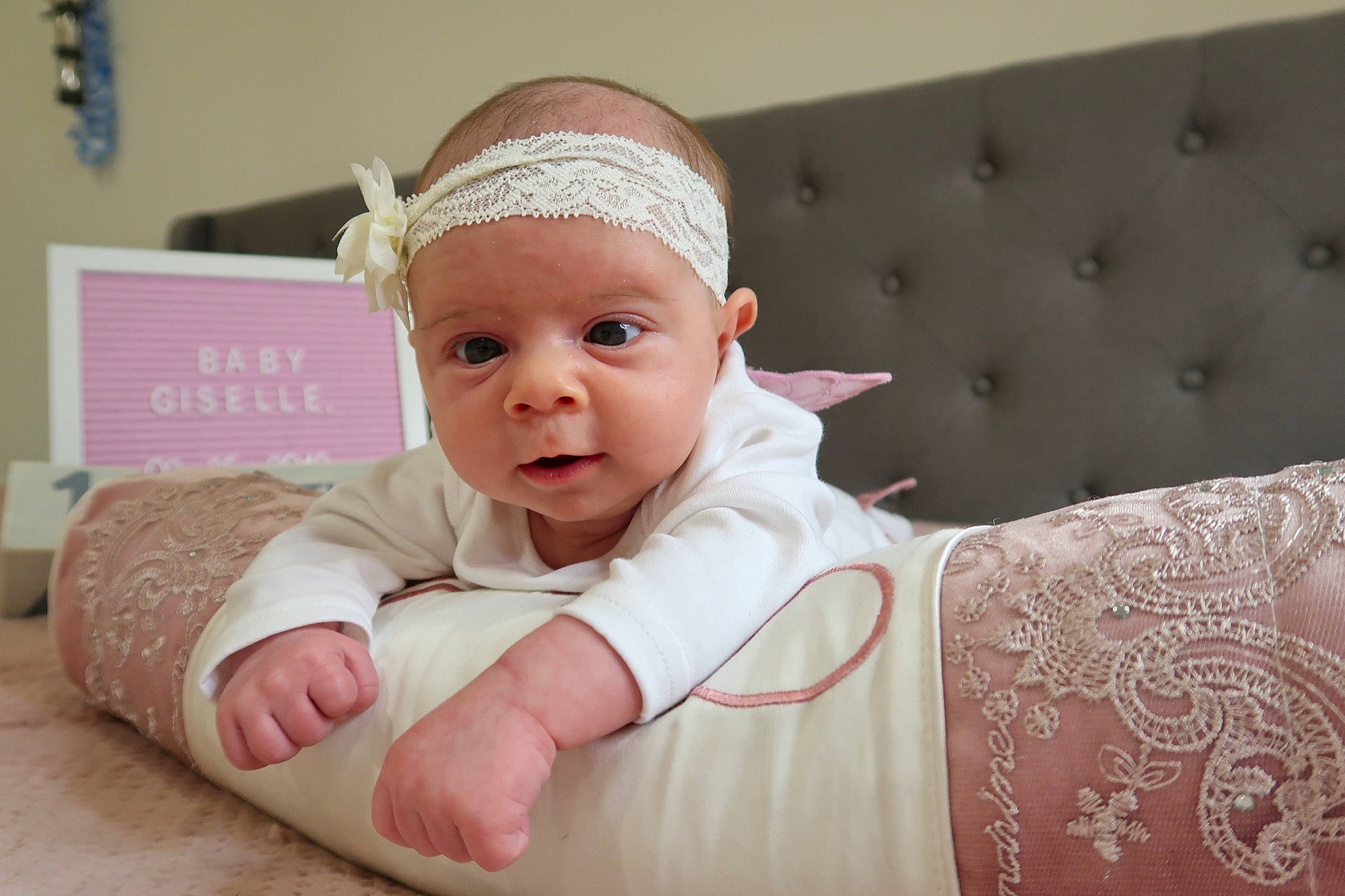 Giselle is registered to the contest to win money with this photo: baby, cheek, child, ear, face, fashion_accessory, hair_accessory, head, headband, headgear, person, pink, skin, smile, toddler
