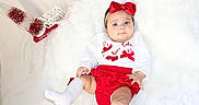 Abby is registered to the contest to win money with this photo: baby, child, christmas_decor, christmas_outfit, cozy, cute, decoration, festive, fluffy_background, holiday, holiday_theme, indoor, infant, portrait, red_bow, red_skirt, smiling, soft_texture, white_socks, white_top