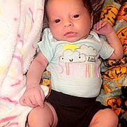 Rynleigh is registered to the contest to win money with this photo: baby, infant, blanket, clothing, cute, face, newborn, person, portrait, soft, toddler, lying, sleepwear, hand, foot, skin, cute_outfit, comfortable, indoor, expression