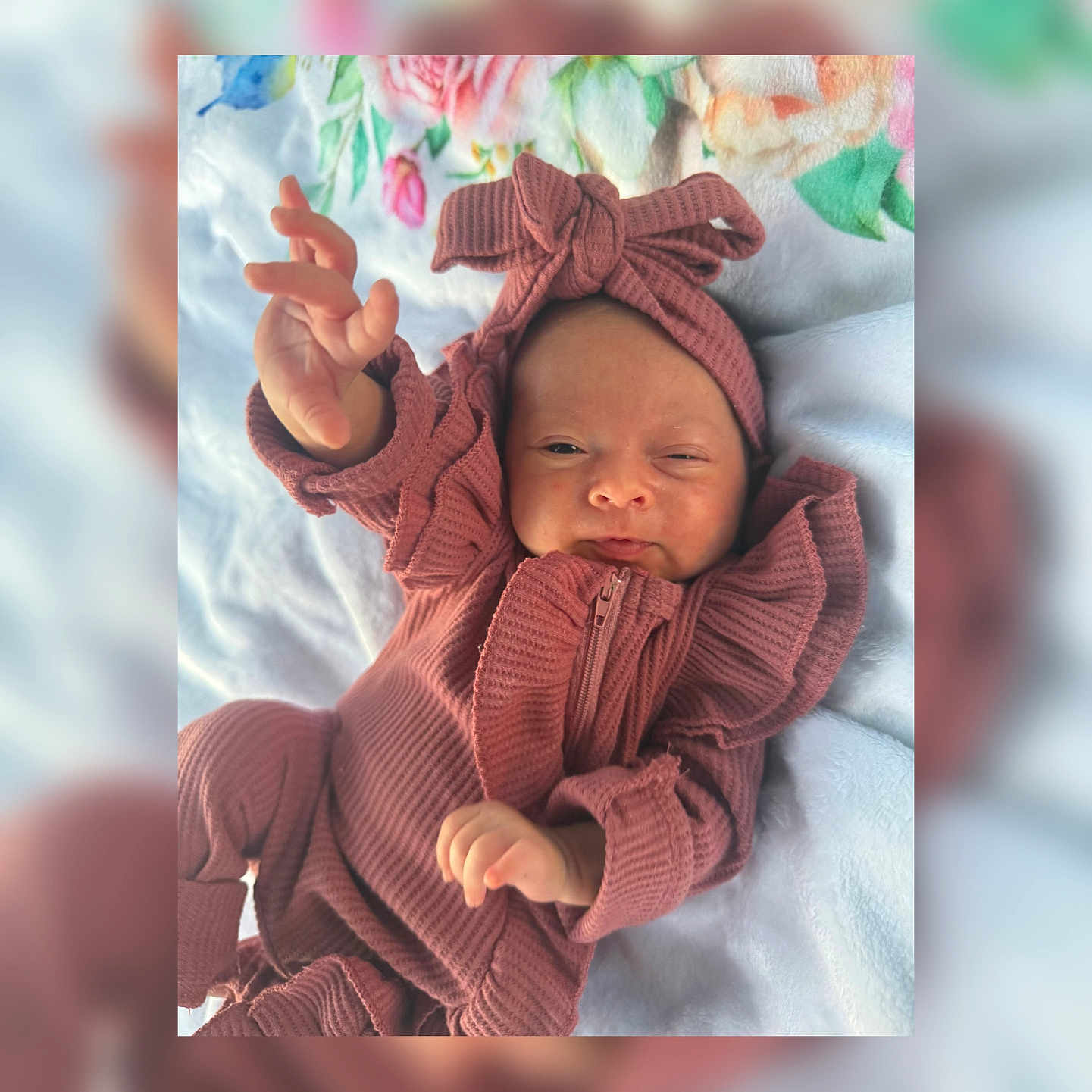 Rynleigh is registered to the contest to win money with this photo: baby, blanket, child, clothing, cozy, cute, expression, face, hand, headband, indoor, infant, lying_down, mauve, newborn, pink, portrait, ruffles, soft_texture, zipped_jumpsuit