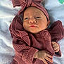 Rynleigh joined the competition — help win amazing prizes! baby, infant, headband, bow, pink_clothing, ruffles, hand, blanket, floral_pattern, soft_texture, lying_down, cute, portrait, newborn, face, skin, expression, indoors, cozy, child