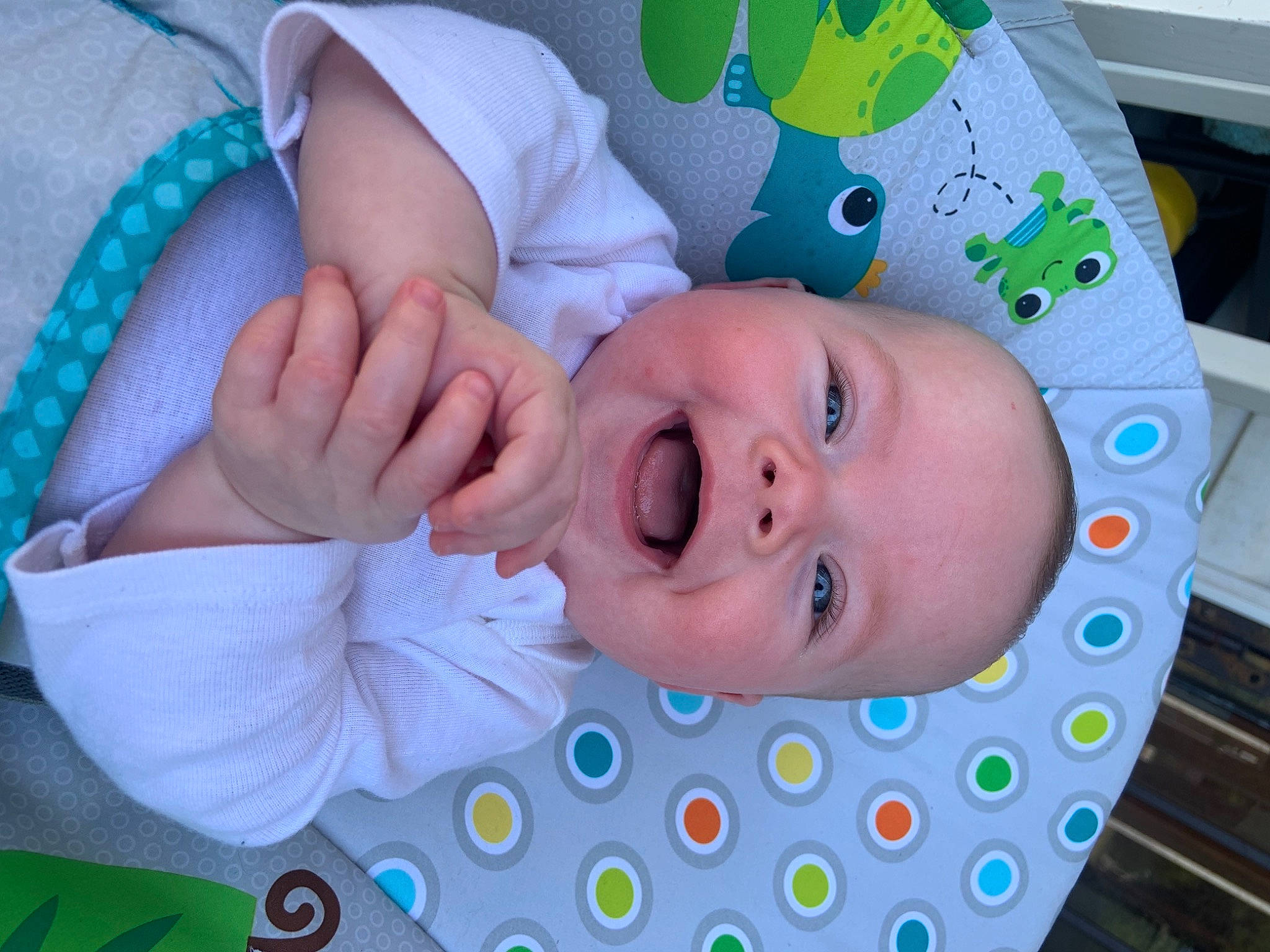 Corinna is registered to the contest to win money with this photo: azure, baby, baby_products, baby_toddler_clothing, blue, cheek, child, facial_expression, finger, gesture, green, happy, mouth, nose, person, pink, product, skin, smile, textile