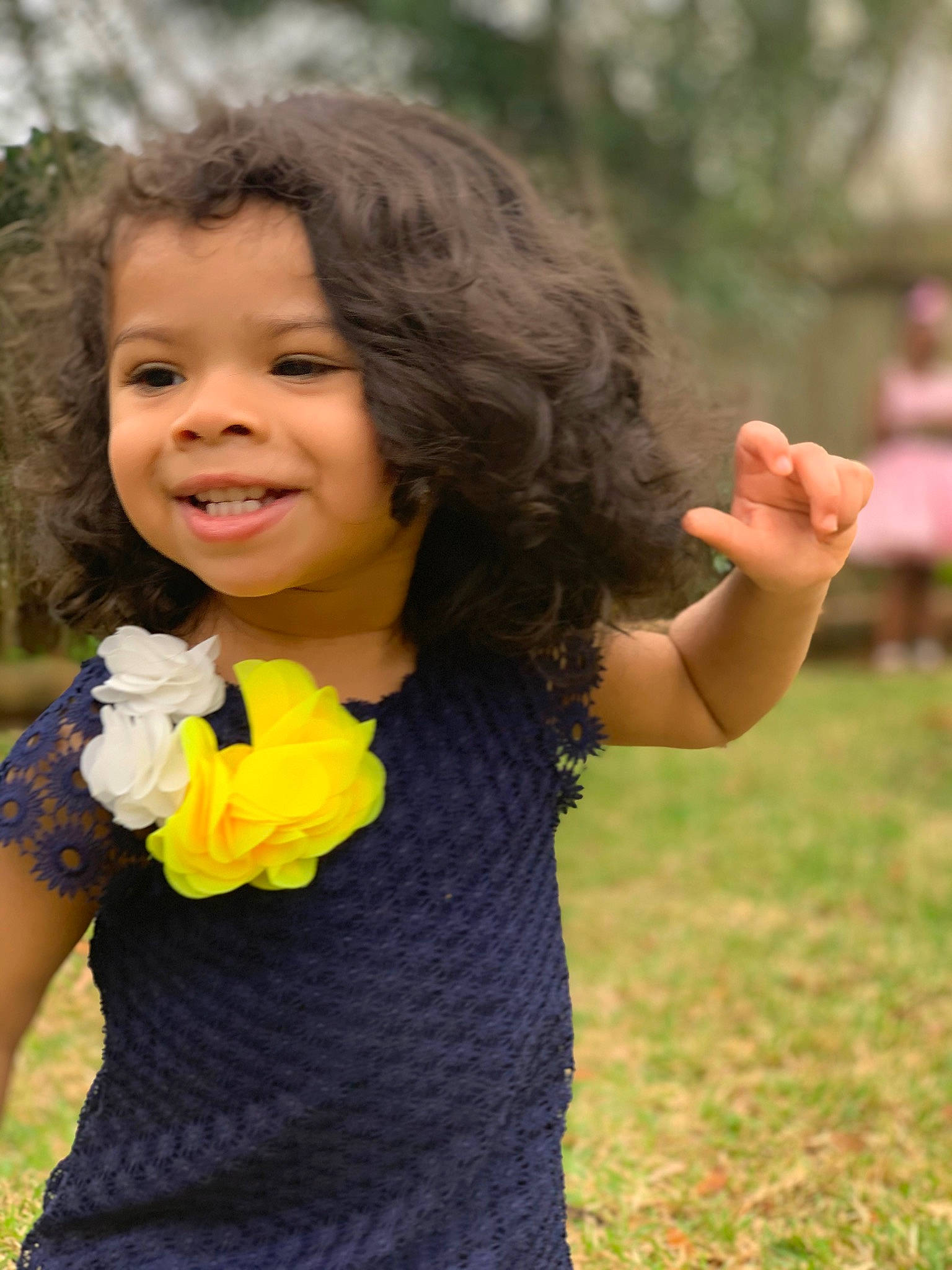 Bella is registered to the contest to win money with this photo: child, flower, gesture, grass, happy, joy, people_in_nature, person, plant, smile, spring, toddler, yellow