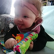 Lyana a rejoint le concours — aidez-le/la à gagner de superbes lots ! baby, child, closeup, clothing, colorful, couch, face, furniture, hair, hand, headband, home, indoor, infant, person, pillow, playful, smile, tongue_out, toy