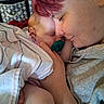 adult, affection, baby, bed, blanket, closeup, cuddle, face, family, gray_shirt, indoor, newborn, pacifier, parent, photography, pink_hair, portrait, sleeping, striped_blanket, tender_moment