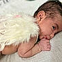 baby, infant, newborn, face, hand, earring, feathers, wings, blanket, sleeping, cute, skin, mouth, lying_down, closeup, soft, peaceful, indoors, portrait, child