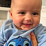 Liyah a rejoint le concours — aidez-le/la à gagner de superbes lots ! baby, child, smiling, blue_clothing, stitch_character, cute, indoor, hand, face, portrait, happy, young_child, sweater, person, infant, closeup, soft_light, warm, expression, holding