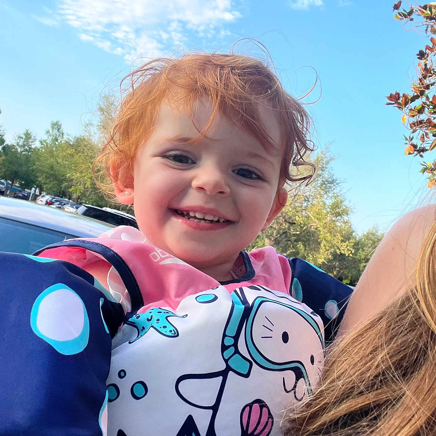 Ruby is registered to the contest to win money with this photo: baby, car, clothing, dress, face, happy, head, laughing, lifejacket, person, photography, plant, portrait, smile, summer, t_shirt, transportation, tree, vehicle, vest