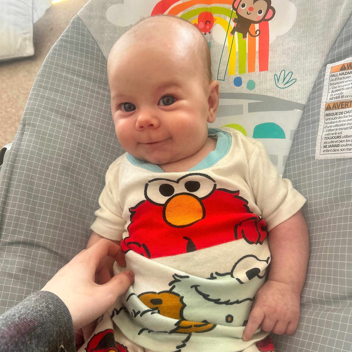 Avery is registered to the contest to win money with this photo: baby, bouncer, cartoon, child, clothing, colorful, comfort, cute, elmo, expression, hand, happy, indoor, infant, pajamas, person, playful, seat, smile, young