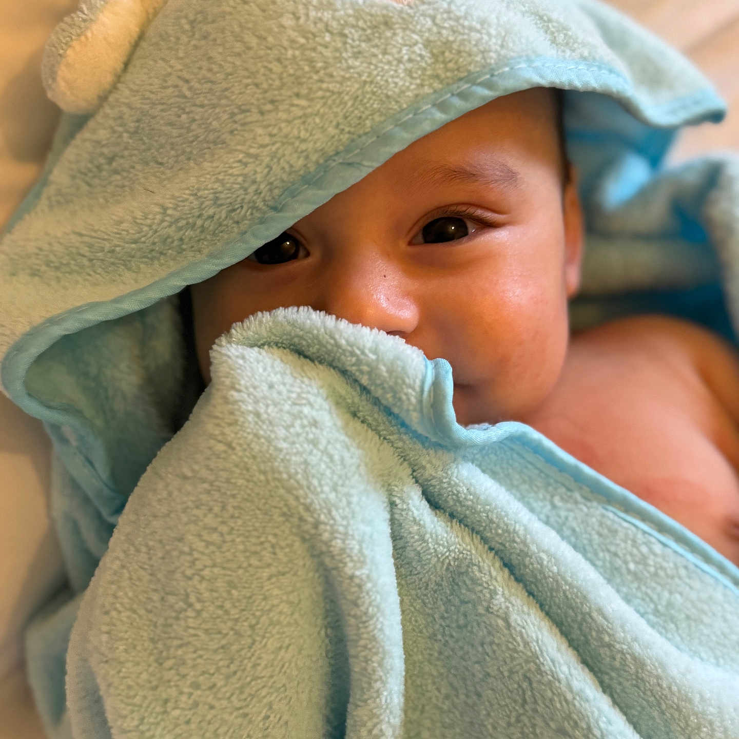 Anas joined the competition — help win amazing prizes! baby, blanket, blue, child, closeup, comfort, cozy, cute, eyes, face, hooded_towel, indoor, infant, person, portrait, skin, soft_texture, towel, warm, wrapped