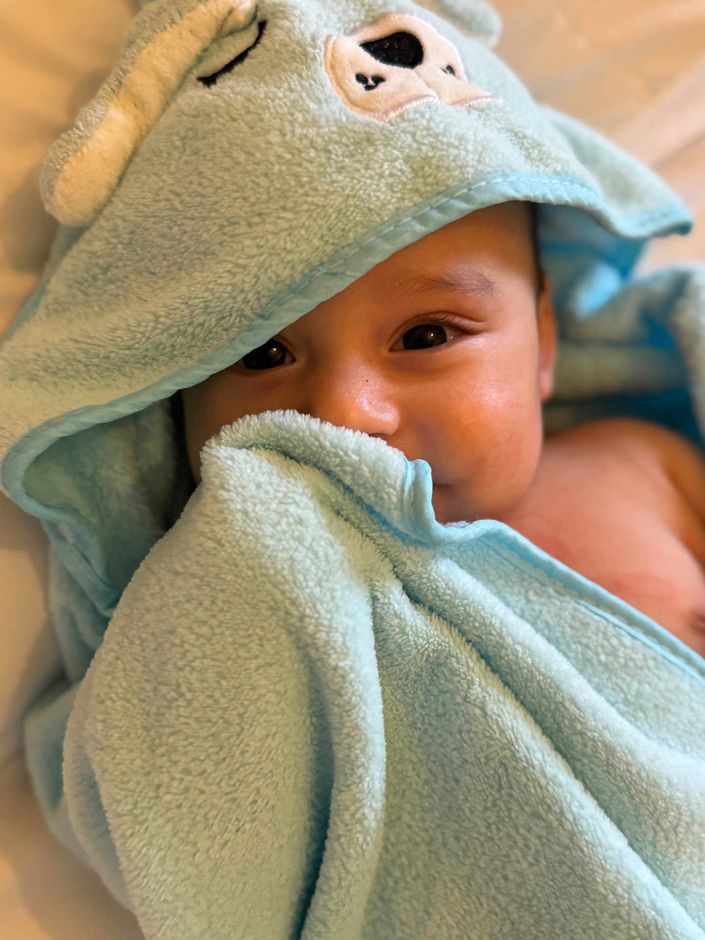 Anas joined the competition — help win amazing prizes! baby, child, towel, hooded_towel, soft_texture, blue, face, eyes, skin, cute, infant, portrait, blanket, wrapped, cozy, indoor, person, closeup, warm, comfort