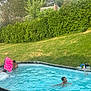 backyard, boogie_board, child, fence, fun, grass, greenery, leisure, nature, outdoor, person, playing, pool_equipment, recreation, splash, summer, sunny, swimming_pool, trees, water