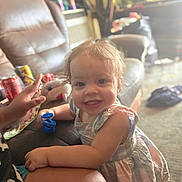 Tammy joined the competition — help win amazing prizes! toddler, child, smile, indoor, living_room, sofa, plush_toy, shark_toy, person, clothing, hand, soda_can, carpet, casual, happy, light, furniture, adult, playful, home