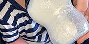 Ava joined the competition — help win amazing prizes! baby, bottle, milk, striped_shirt, hand, pacifier, feeding, infant, closeup, blue_eyes, person, clothing, holding, sitting, cute, skin, nursing, feeding_bottle, child, apparel