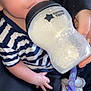 baby, bottle, milk, striped_shirt, hand, pacifier, feeding, infant, closeup, blue_eyes, person, clothing, holding, sitting, cute, skin, nursing, feeding_bottle, child, apparel