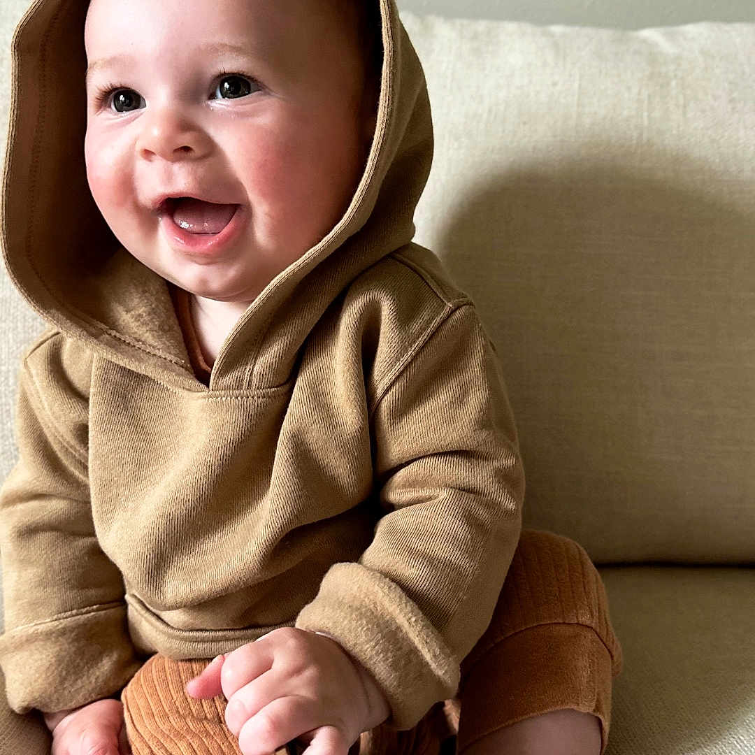 William joined the competition — help win amazing prizes! baby, babylaughing, bodypart, clothing, face, finger, hand, happy, head, hood, hoodie, knitwear, laughing, person, photography, portrait, sitting, smile, sweater, sweatshirt