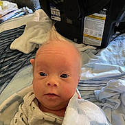 Luca joined the competition — help win amazing prizes! baby, infant, child, portrait, face, eyes, looking_at_camera, wide_eyed, indoors, bedroom, blanket, white_blanket, onesie, bedding, bed, household, car_seat, clothing, close_up, natural_light