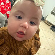 Aitana joined the competition — help win amazing prizes! baby, child, face, headband, bow, sweater, knitted, brown, indoors, floor, tile, furniture, person, cute, closeup, portrait, young, infant, expression, curious