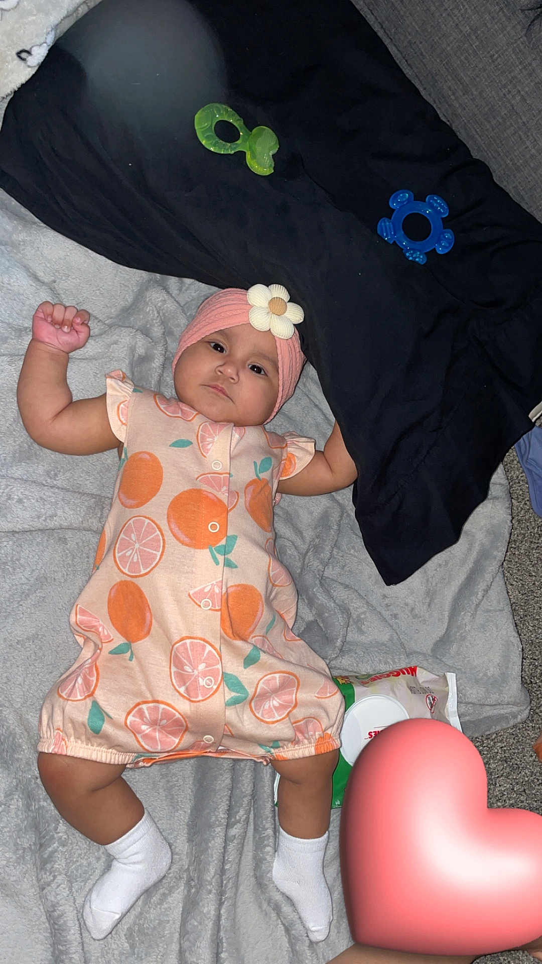 Avellana joined the competition — help win amazing prizes! baby, infant, child, blanket, headband, flower, toy, socks, clothing, lying_down, carpet, soft_texture, pink, peach_pattern, white_socks, cute, indoors, floor, heart_emoji, playtime