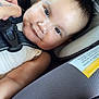 baby, car_seat, child, smile, face, infant, seatbelt, hand, clothing, straps, comfort, cute, closeup, person, skin, head, expression, young, indoors, happy