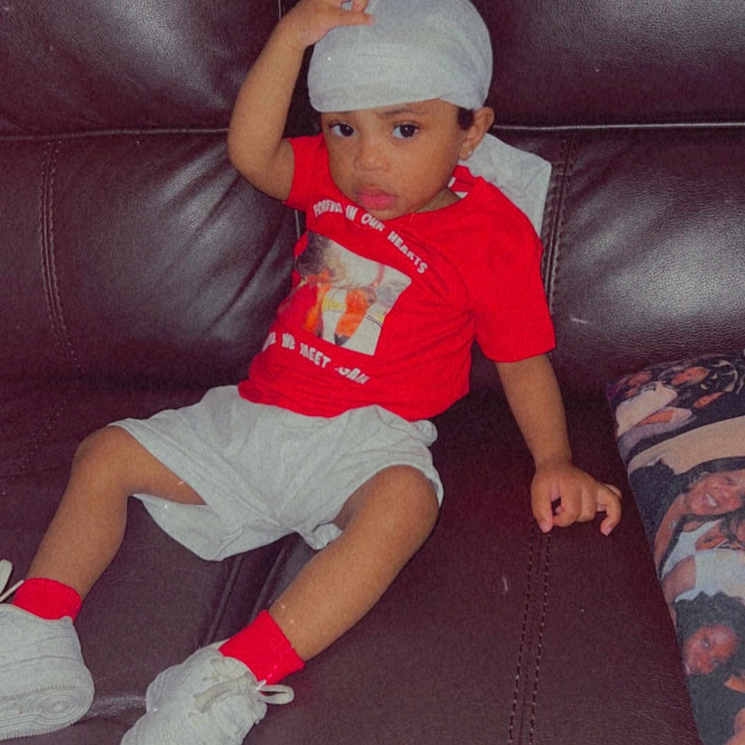 Aking joined the competition — help win amazing prizes! baseballcap, boy, cap, child, clothing, couch, cushion, face, footwear, furniture, hat, head, homedecor, male, pants, person, photography, portrait, shoe, sitting