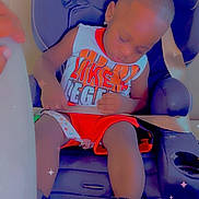 Christian is registered to the contest to win money with this photo: toddler, child, car_seat, sleeping, seatbelt, sneakers, clothing, indoor, baby, resting, nap, vehicle, seat, footwear, cute, infant, safety, colorful, casual, peaceful