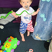 Joseph joined the competition — help win amazing prizes! toddler, child, pacifier, toy, carpet, blanket, indoor, clothing, shorts, shirt, baby, face, foot, hand, smile, play, colorful, furniture, floor, room