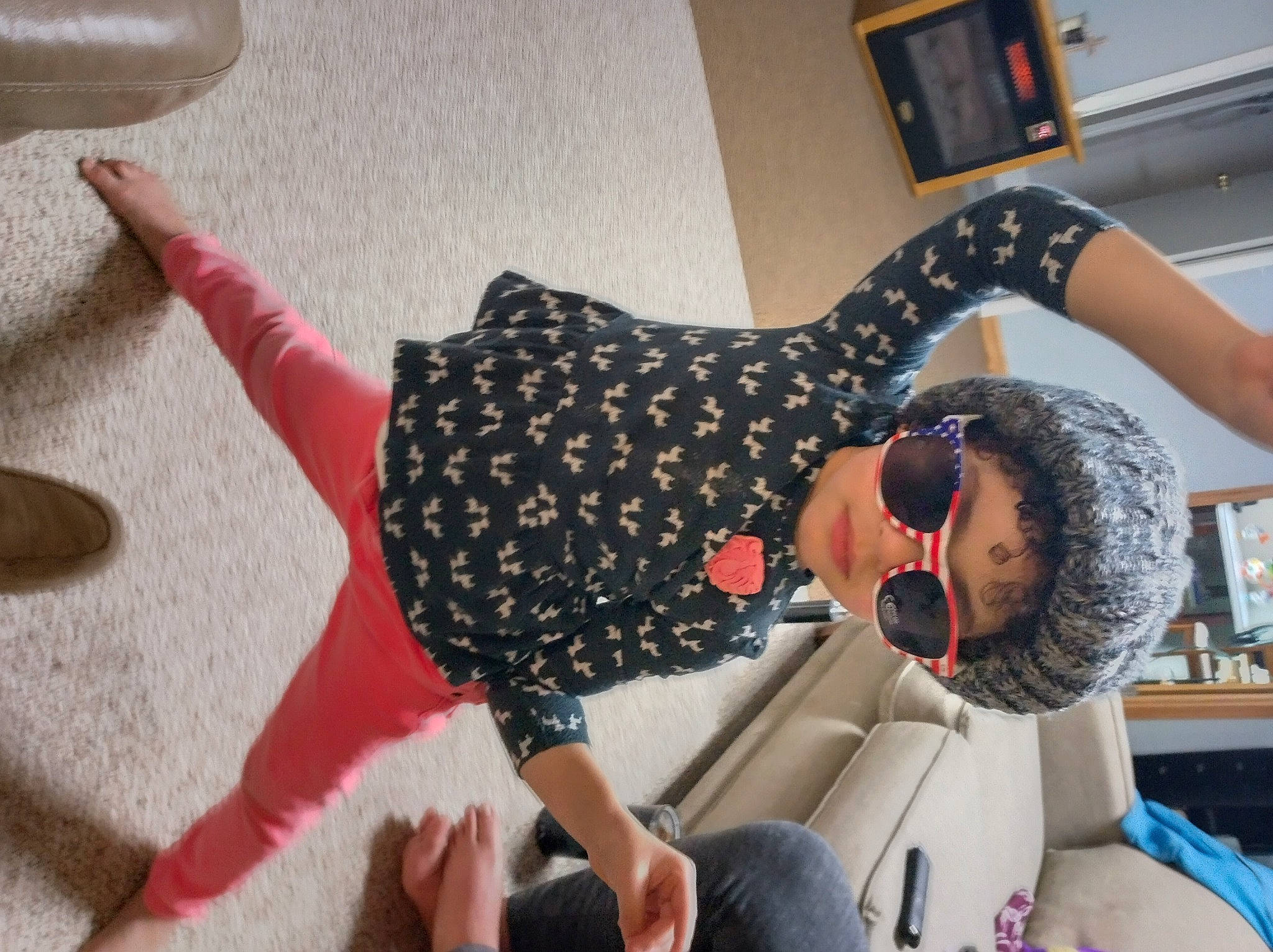 Harper is registered to the contest to win money with this photo: comfort, elbow, eyewear, finger, flooring, fun, goggles, happy, human_leg, joint, knee, leisure, pattern, person, shoulder, sitting, sunglasses, thigh, trunk, waist