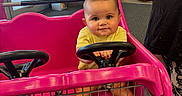 Aurora joined the competition — help win amazing prizes! baby, shopping_cart, pink, child, steering_wheel, indoor, store, tattoo, hand, person, floor, clothing, window, door, product_stack, car_cart, foot, metal, plastic, curious