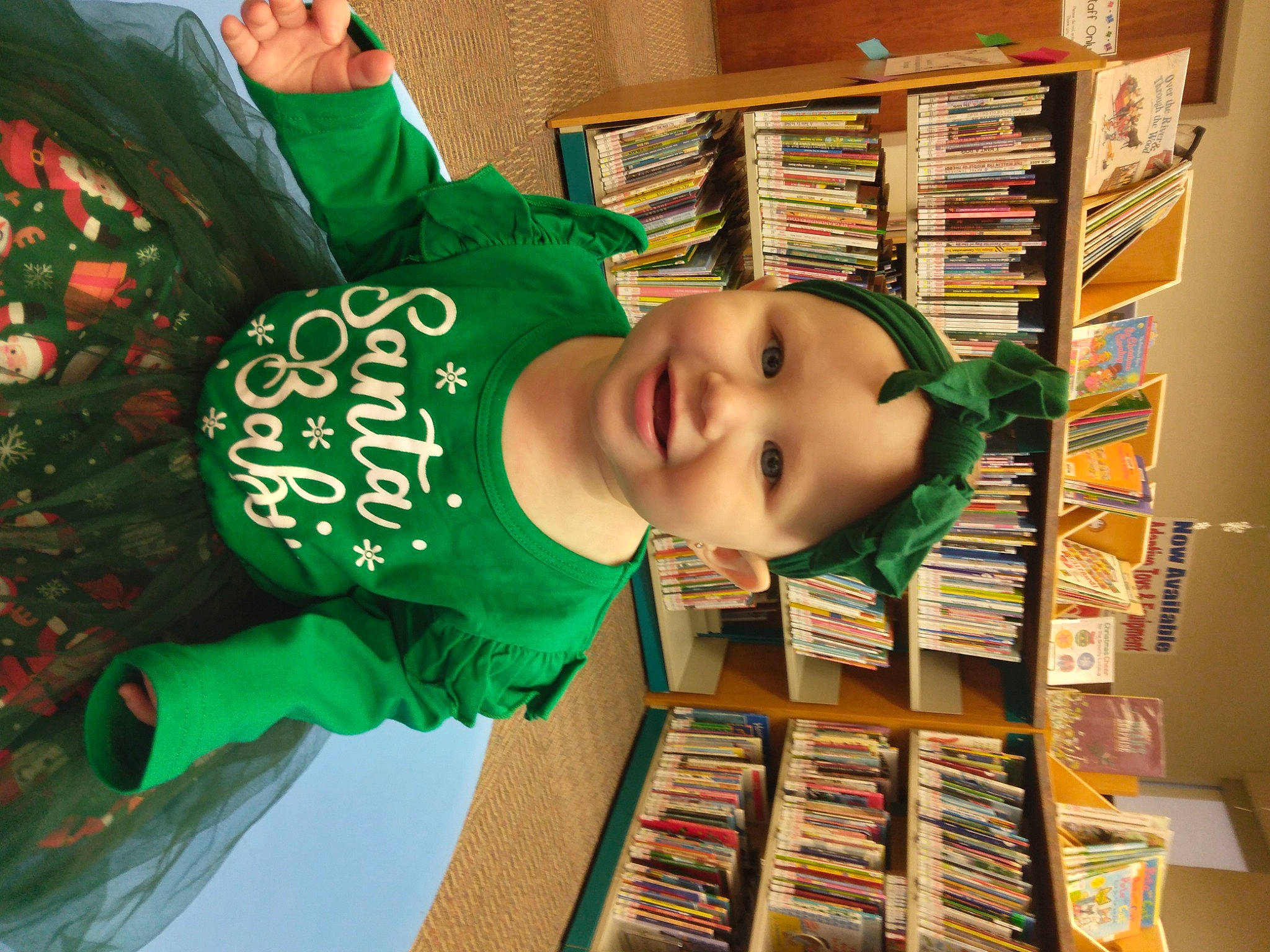 Annalee joined the competition — help win amazing prizes! baby, book, bookcase, child, collection, event, fun, green, happy, headwear, joy, person, publication, retail, room, shelf, shelving, smile, toddler