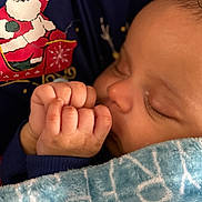 Khyreese is registered to the contest to win money with this photo: baby, sleeping, hand, blanket, clothing, santa_claus, holiday, closeup, cute, infant, child, face, skin, peaceful, portrait, warm, cozy, soft, resting, toddler