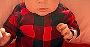 Malakai Boyd is registered to the contest to win money with this photo: baby, background, black, checkered, child, clothing, curious, cute, eyes, face, hands, indoor, infant, onesie, pink, plaid, portrait, red, sitting, soft