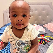 Reign joined the competition — help win amazing prizes! baby, bed, cartoon, child, clothing, cute, expression, face, hair, hand, head, indoor, infant, onesie, person, pillow, skin, smile, topknot, toy