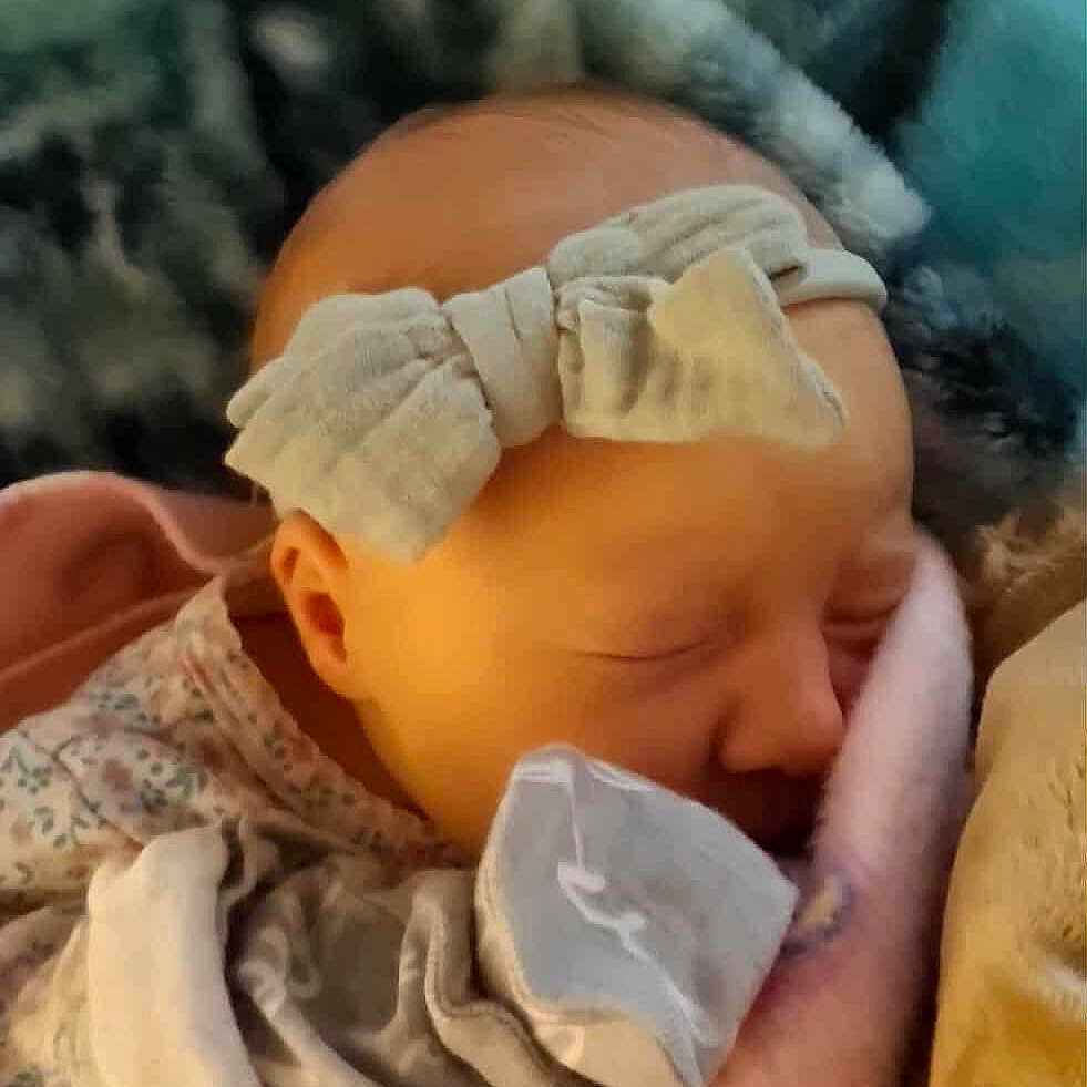 Braelynn is registered to the contest to win money with this photo: baby, blanket, bow, child, closeup, cozy, cute, fabric, face, headband, indoors, infant, newborn, peaceful, portrait, resting, sleeping, soft, warm, wrapped