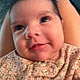Athena is registered to the contest to win money with this photo: baby, infant, smiling, face, closeup, floral_clothing, cute, child, skin, eyes, person, portrait, newborn, happy, young, indoors, soft_light, comfort, resting, baby_clothes