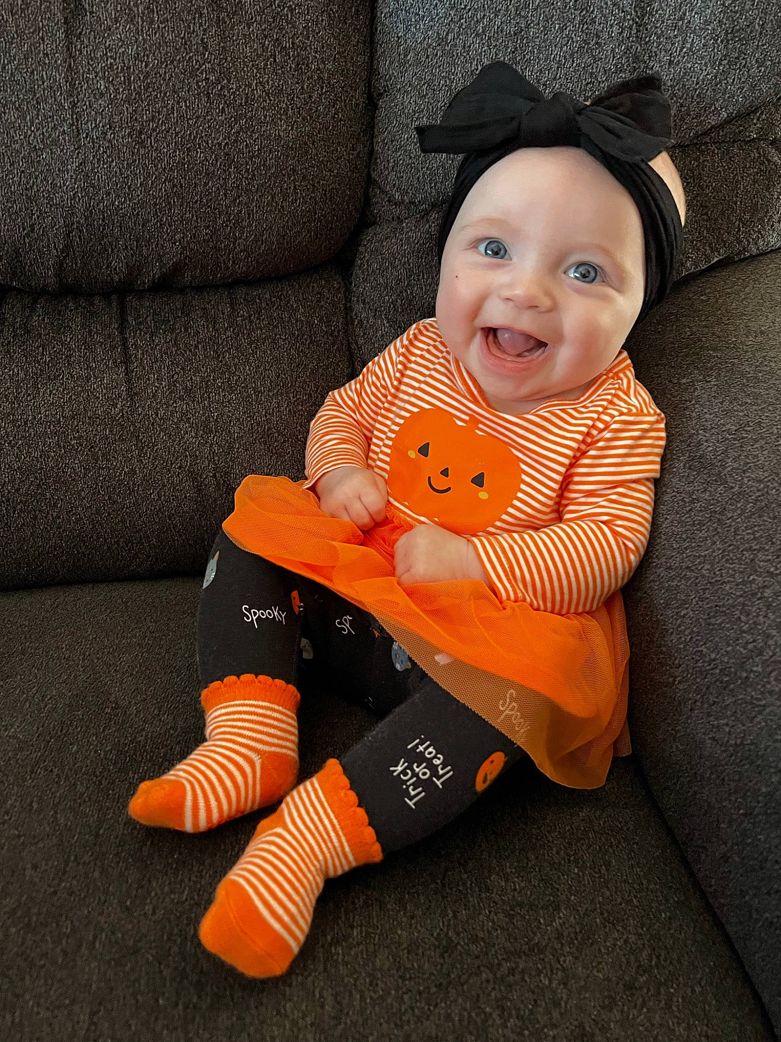 Kinley is registered to the contest to win money with this photo: baby, baby_products, baby_toddler_clothing, baby_toys, child, comfort, eye, flooring, fun, headwear, human_leg, knee, orange, person, personal_protective_equipment, sitting, sleeve, smile, stuffed_toy, textile