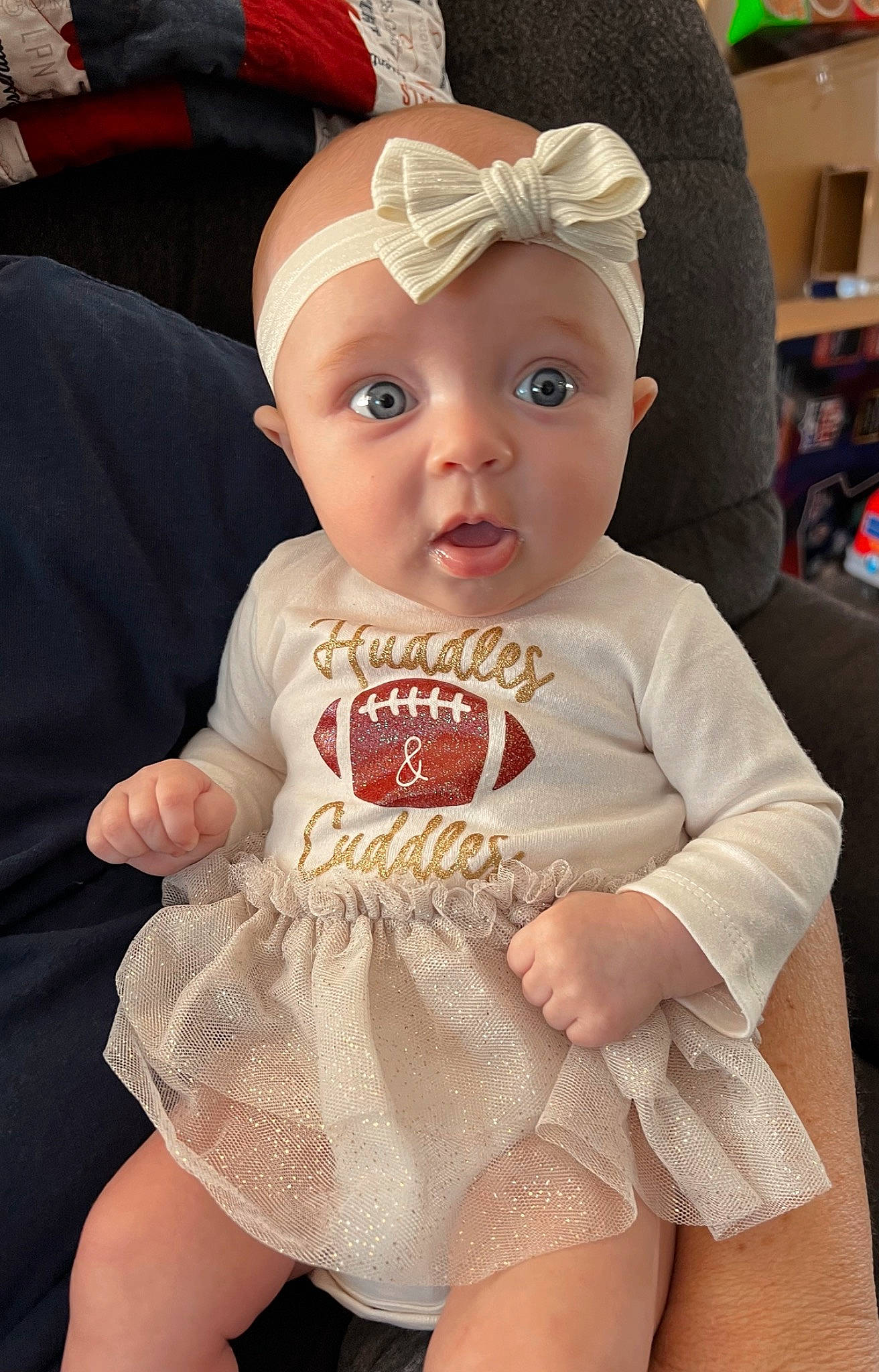 Kinley is registered to the contest to win money with this photo: baby, baby_toddler_clothing, cap, cheek, child, costume_hat, day_dress, embellishment, eyelash, fashion_accessory, headband, headpiece, human_leg, jewellery, lip, necklace, person, skin, sleeve, surprise