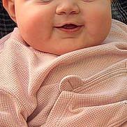 Siryna is registered to the contest to win money with this photo: baby, infant, face, blue_eyes, pink_clothing, smile, chubby_cheeks, portrait, close_up, cute, child, soft_texture, knitwear, hand, person, young_child, warm_clothing, skin, eyebrows, eyelashes