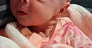 Serenity joined the competition — help win amazing prizes! baby, infant, child, portrait, close_up, wide_eyed, looking_at_camera, pink_clothing, blanket, soft_blanket, striped_background, indoor, cozy, lying_down, face, head, eyes, nose, photography, adorable