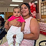 Landon joined the competition — help win amazing prizes! adult, baby, balloons, candid, celebration, chair, child, decorations, family, indoor, mother, photograph, pink_shirt, portrait, sitting, smiling, sneakers, stroller, table, white_pants