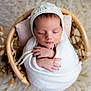 newborn, baby, sleeping, wrapped, blanket, knit, bonnet, basket, wicker, cozy, soft, peaceful, infant, cute, hands, closed_eyes, portrait, indoor, warm, cushion